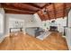 Open living room showcasing beautiful hardwood floors, wood ceiling beams, and a classic fireplace at 3962 Fairington Dr, Marietta, GA 30066