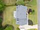 Aerial view of a house with a large yard, mature trees, deck, and a paved driveway at 5711 Brynwood Nw Cir, Acworth, GA 30101