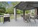 Back deck with a grill and outdoor dining table underneath a gazebo at 5711 Brynwood Nw Cir, Acworth, GA 30101