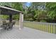 Backyard deck with a gazebo, dining table, and a view of the green lawn at 5711 Brynwood Nw Cir, Acworth, GA 30101