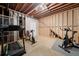 Unfinished basement space with fitness equipment and exposed beams at 5711 Brynwood Nw Cir, Acworth, GA 30101