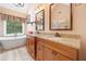 Luxurious bathroom featuring double sinks, granite countertops, a soaking tub, and modern fixtures at 5711 Brynwood Nw Cir, Acworth, GA 30101