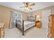 Bedroom features ceiling fan, window with natural light and comfortable bed at 5711 Brynwood Nw Cir, Acworth, GA 30101