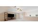 A spacious bonus room with neutral walls, built-in shelving, and a ceiling fan at 5711 Brynwood Nw Cir, Acworth, GA 30101