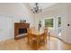 Bright dining room featuring a fireplace, wood floors, and a charming chandelier at 5711 Brynwood Nw Cir, Acworth, GA 30101