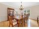 Elegant dining room with a large table, chandelier, hardwood floors, and natural light from the windows at 5711 Brynwood Nw Cir, Acworth, GA 30101