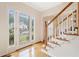 Bright foyer with hardwood floors, decorative glass door, and elegant staircase at 5711 Brynwood Nw Cir, Acworth, GA 30101