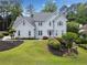 Charming two-story home with a well-manicured lawn and a combination of green trees and colorful landscaping at 5711 Brynwood Nw Cir, Acworth, GA 30101