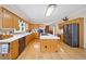 Spacious kitchen with wooden cabinetry, stainless steel appliances, a center island and hardwood floors at 5711 Brynwood Nw Cir, Acworth, GA 30101