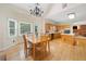 Bright kitchen featuring wooden cabinets, island cooktop, and a dining area with large windows at 5711 Brynwood Nw Cir, Acworth, GA 30101