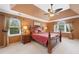A calming main bedroom features a tray ceiling and windows with natural light at 5711 Brynwood Nw Cir, Acworth, GA 30101