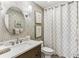 Charming bathroom with stylish vanity, decorative mirror, and patterned wallpaper at 80 Maryeanna Dr, Sandy Springs, GA 30342
