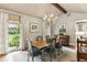 Bright dining room featuring a chandelier, large windows with backyard views, and elegant decor at 80 Maryeanna Dr, Sandy Springs, GA 30342