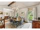 Chic dining room with a wooden table and chairs beneath a decorative chandelier, and sunlit windows at 80 Maryeanna Dr, Sandy Springs, GA 30342