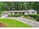Charming one-story home features a brick facade, attached garage, and a beautifully landscaped front yard at 80 Maryeanna Dr, Sandy Springs, GA 30342