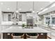 Bright and modern kitchen featuring a large island with seating, stainless steel appliances, and ample storage space at 80 Maryeanna Dr, Sandy Springs, GA 30342