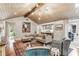 Stylish living room featuring comfortable seating, a decorative rug, and a view of the adjacent kitchen area at 80 Maryeanna Dr, Sandy Springs, GA 30342
