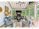 Inviting sunroom with a brick fireplace, ceiling fan and comfortable seating area at 80 Maryeanna Dr, Sandy Springs, GA 30342