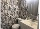 Quaint half bathroom featuring white fixtures and unique wallpaper at 20 Marietta Nw St # 13C, Atlanta, GA 30303