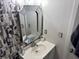 Bright bathroom featuring a decorative mirror and white vanity with storage at 20 Marietta Nw St # 13C, Atlanta, GA 30303