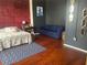 Bedroom featuring a bed, blue couch, and wood floors at 20 Marietta Nw St # 13C, Atlanta, GA 30303