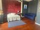 Bedroom featuring a bed, blue couch, and wood floors at 20 Marietta Nw St # 13C, Atlanta, GA 30303
