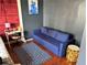 Cozy bedroom features a blue sofa and a striking piece of modern art above it at 20 Marietta Nw St # 13C, Atlanta, GA 30303