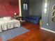 Modern bedroom with a plush bed, sleek desk, blue sofa, and stylish gold accents at 20 Marietta Nw St # 13C, Atlanta, GA 30303