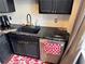 Kitchen with black cabinets, black granite countertop, and stainless steel dishwasher at 20 Marietta Nw St # 13C, Atlanta, GA 30303