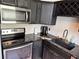 Modern kitchen featuring stainless steel appliances and stylish dark cabinets at 20 Marietta Nw St # 13C, Atlanta, GA 30303