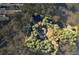 Aerial view of a sprawling property with a home, tennis court, and surrounded by trees at 200 Mcguirts Bridge Rd, Covington, GA 30014