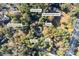 Aerial view of estate featuring a home, tennis court, basketball court, gazebo, garage, and wooded acreage at 200 Mcguirts Bridge Rd, Covington, GA 30014