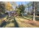 Large backyard with mature trees, a brick outbuilding, and well-maintained lawn at 200 Mcguirts Bridge Rd, Covington, GA 30014