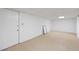 Unfinished basement with tile flooring, white walls, and a door at 200 Mcguirts Bridge Rd, Covington, GA 30014