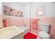 Pink tiled bathroom with a vanity, toilet, and bathtub featuring matching decor at 200 Mcguirts Bridge Rd, Covington, GA 30014