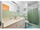 Vintage green tiled bathroom with glass shower, white vanity and plenty of natural light at 200 Mcguirts Bridge Rd, Covington, GA 30014