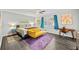 Bright bedroom with a ceiling fan, desk, artwork, and a comfortable bed with throw pillows at 200 Mcguirts Bridge Rd, Covington, GA 30014