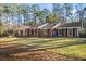 Expansive brick home with a well-maintained lawn and classic architectural details at 200 Mcguirts Bridge Rd, Covington, GA 30014