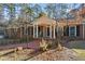 Charming brick home featuring a welcoming front porch with white columns and shuttered windows at 200 Mcguirts Bridge Rd, Covington, GA 30014
