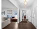 Hallway with hardwood floors, white trim, and a decorative light fixture at 200 Mcguirts Bridge Rd, Covington, GA 30014