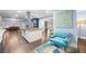 Open kitchen with stainless steel appliances, island, and seating area with eye-catching blue furniture and decor at 200 Mcguirts Bridge Rd, Covington, GA 30014