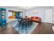 Open-concept living area with stylish furnishings, including a sofa, table with chairs, and a blue cabinet at 200 Mcguirts Bridge Rd, Covington, GA 30014