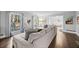 Bright living room with a sectional sofa, hardwood floors, and large windows at 200 Mcguirts Bridge Rd, Covington, GA 30014