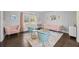 Cozy living room featuring pink sofas, blue chairs, and hardwood floors at 200 Mcguirts Bridge Rd, Covington, GA 30014