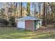 Backyard storage shed with a garage door at 200 Mcguirts Bridge Rd, Covington, GA 30014