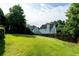 Spacious backyard featuring a well maintained lawn, wooden fence, and mature trees offering great privacy at 2163 Berryhill Se Cir, Smyrna, GA 30082