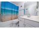 Well-lit bathroom featuring a shower-tub combo with a blue ocean-themed shower curtain at 2163 Berryhill Se Cir, Smyrna, GA 30082