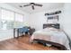 Bedroom with hardwood floors, a ceiling fan, natural light, and a bed and desk at 2163 Berryhill Se Cir, Smyrna, GA 30082