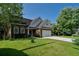 Beautiful brick home with a two-car garage, surrounded by lush greenery and a well-kept lawn at 2163 Berryhill Se Cir, Smyrna, GA 30082