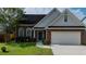 Charming one story brick home with a well manicured lawn, two-car garage, and inviting blue front door at 2163 Berryhill Se Cir, Smyrna, GA 30082